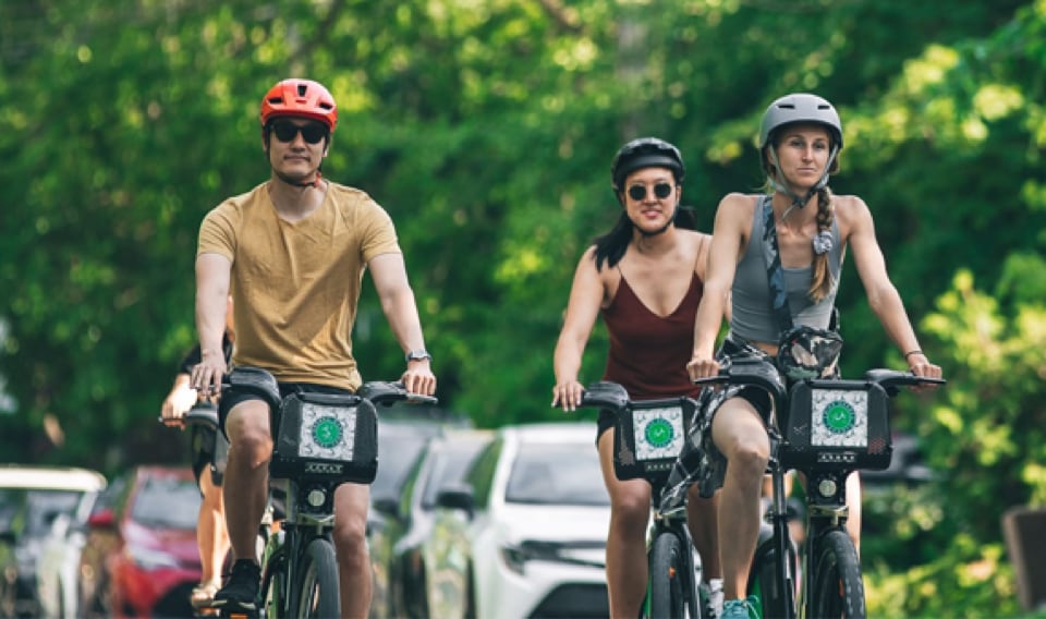 three people riding city bikes